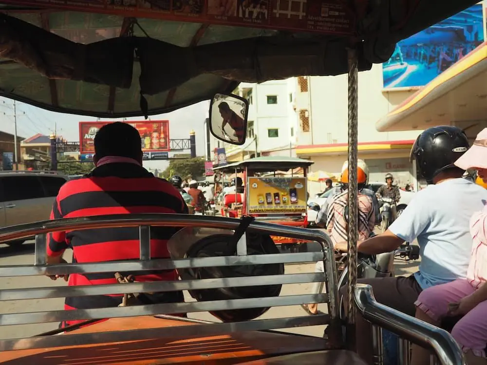 In the back of a tuk-tuk through the streets of Phnom Penh