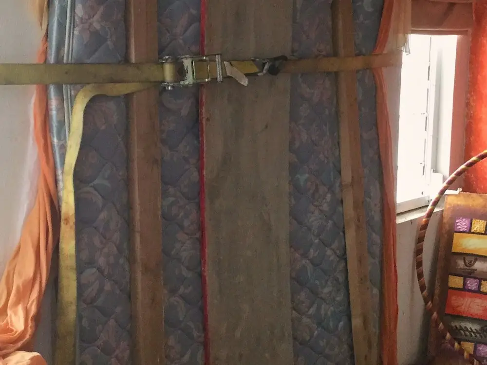 Barricades inside house ahead of Hurricane Jose A mattress is strapped against a window a patio door