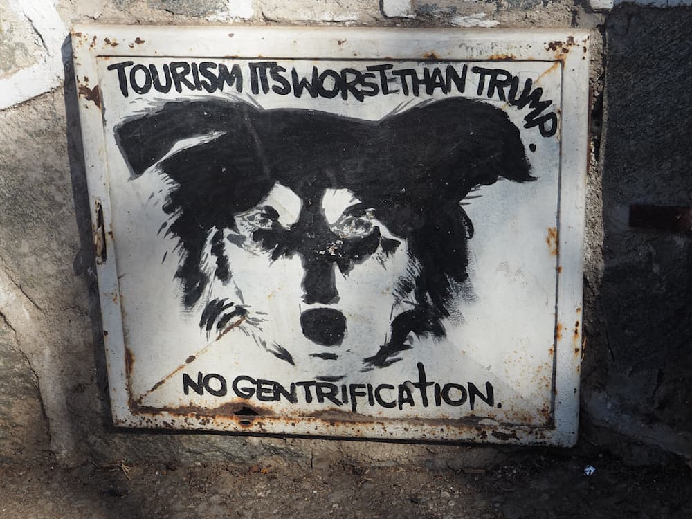 Sign which says "Tourism is worse than Trump - no gentrification"