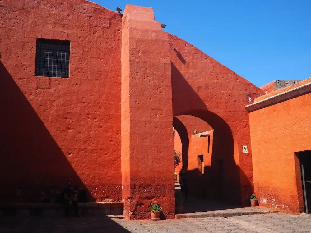 A red wall against a blue sky