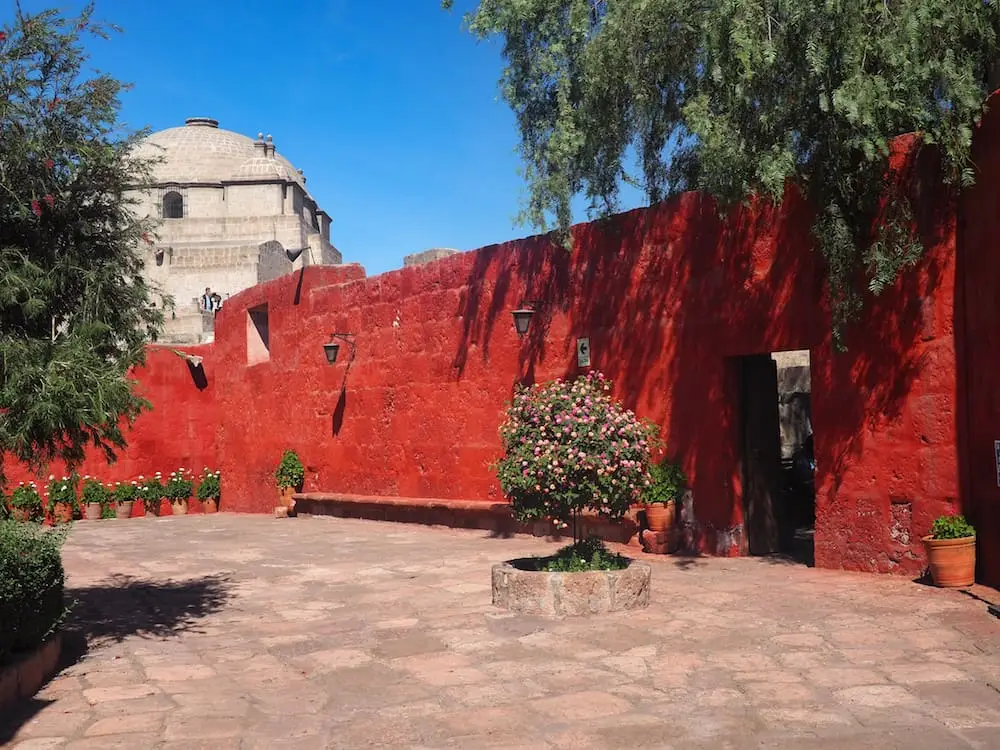 A red wall against a blue sky