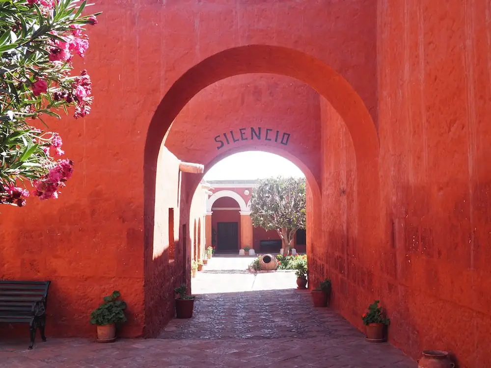 A sign requests "silence" near the entrance to the monastery
