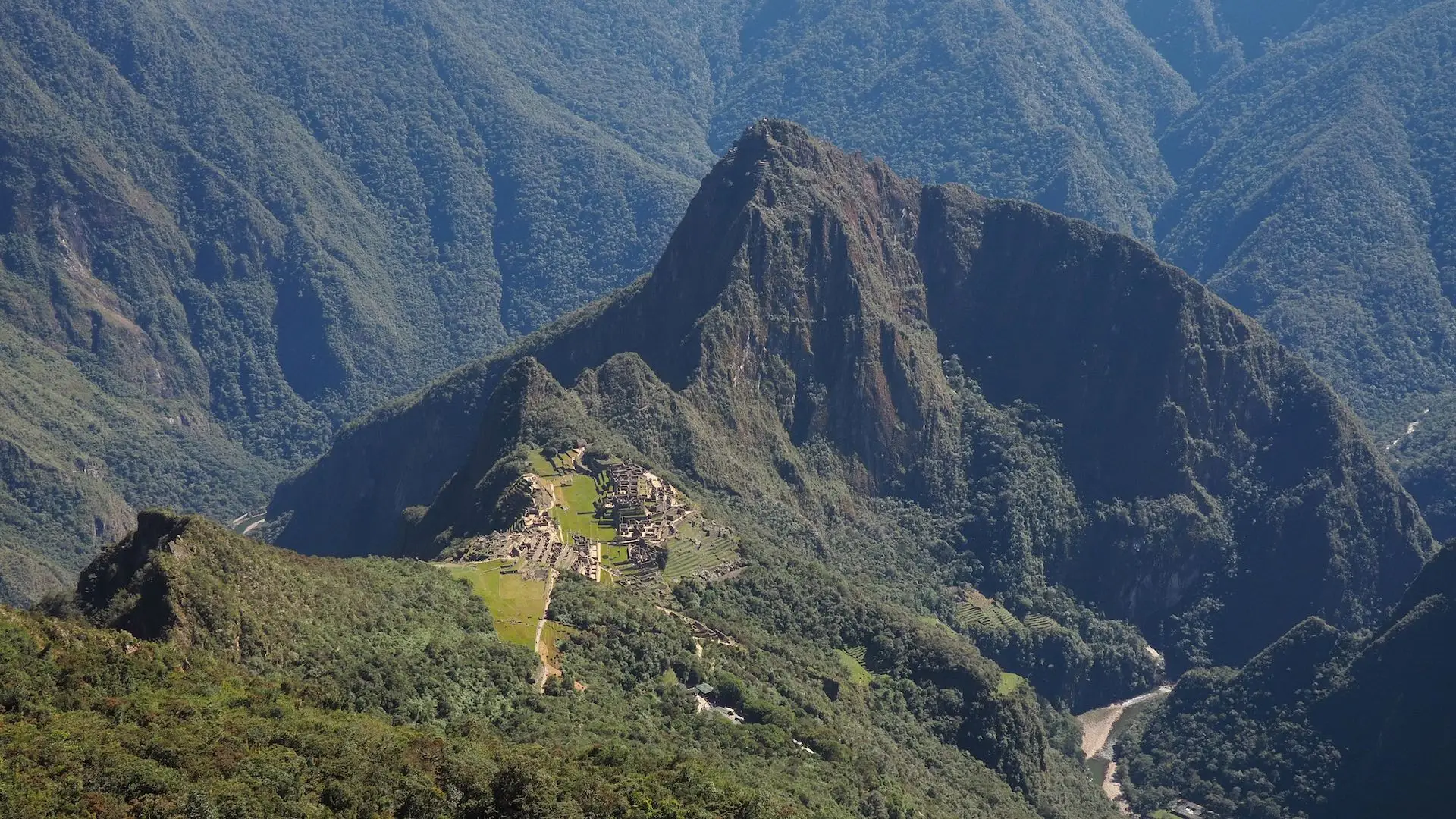 A ruined city set amidst a landscape of jungle-clad mountains