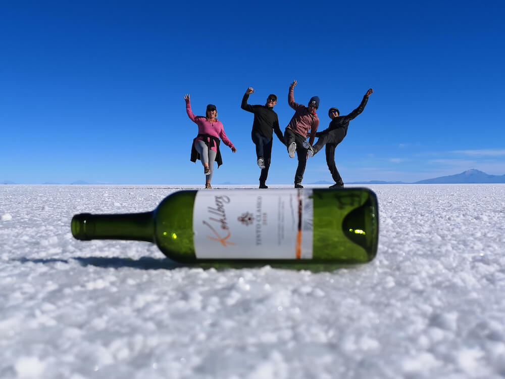 Perspective photo - four of us balaning on a wine bottle