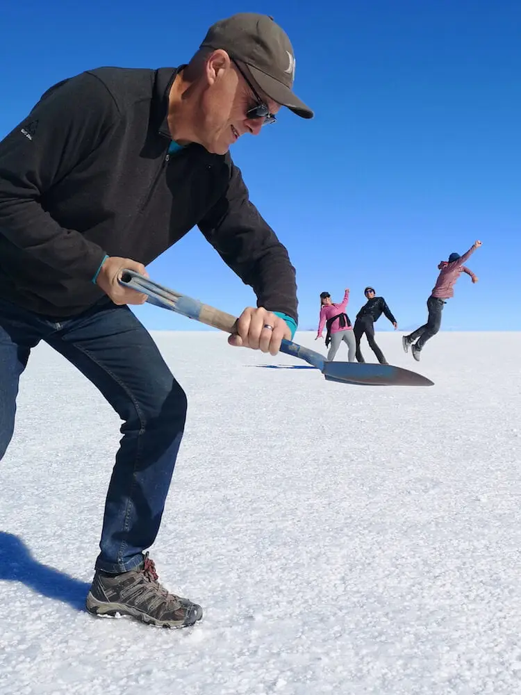 Perspective photo - Ian picking up the other three with a shovel
