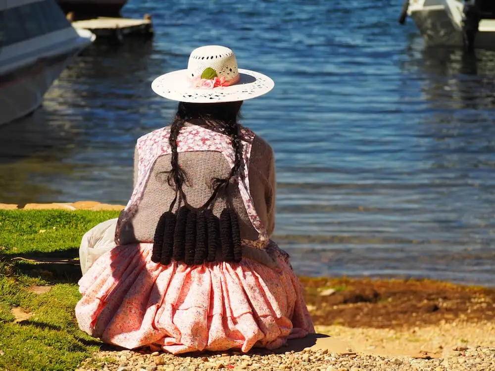 A local woman sits and waits for the boat from Copacabana to arrive