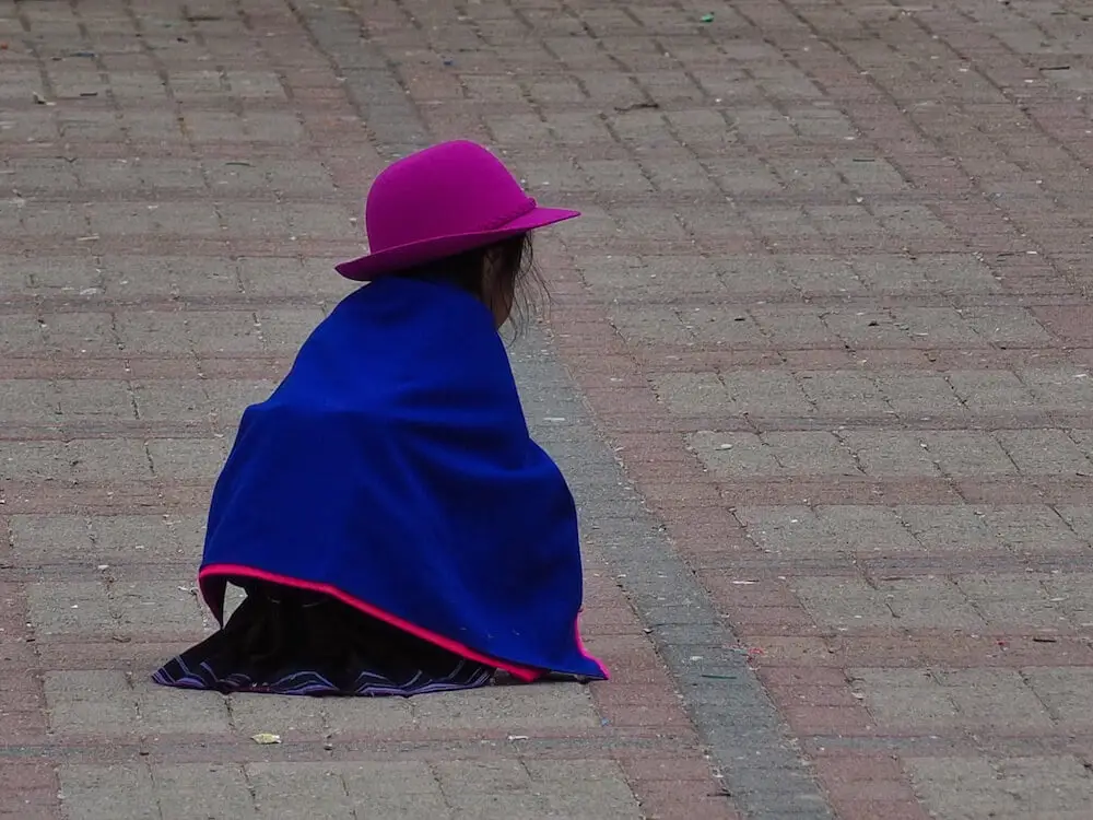 A small child crouching in the main square