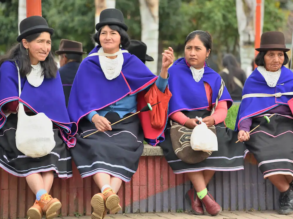 Four ladies sitting on a bench
