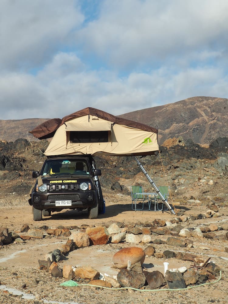 Rooftop tent opened out over jeep