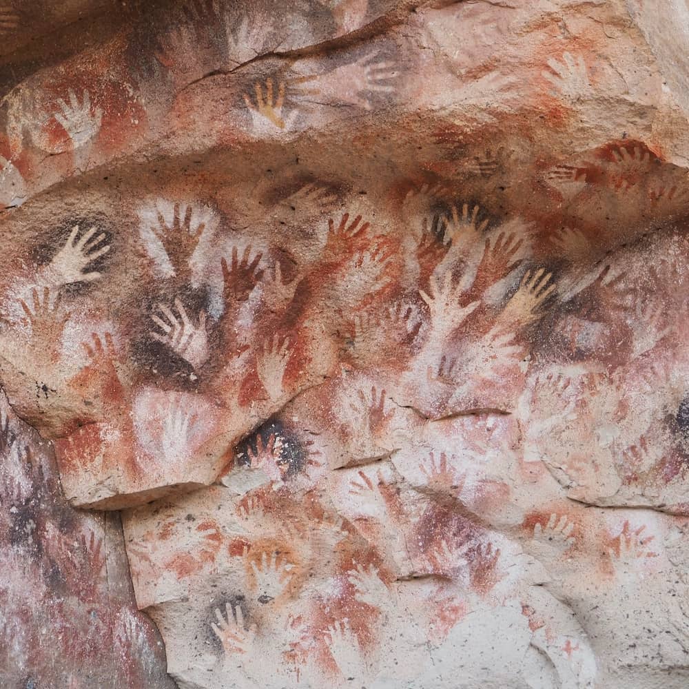 Prehistoric hand imprints on a cave wall