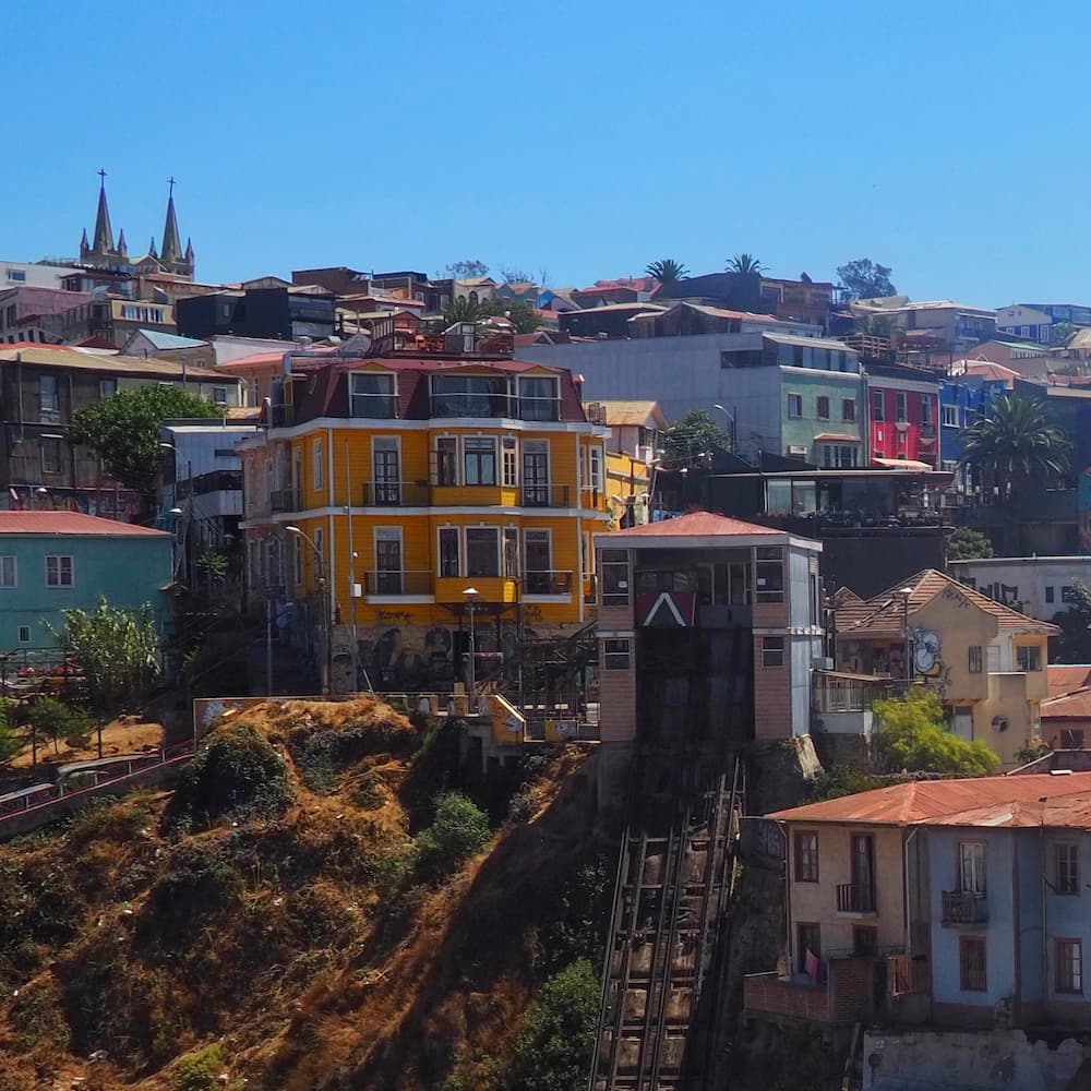 Coloured buildings on a hill with a funicular lift in the foreground