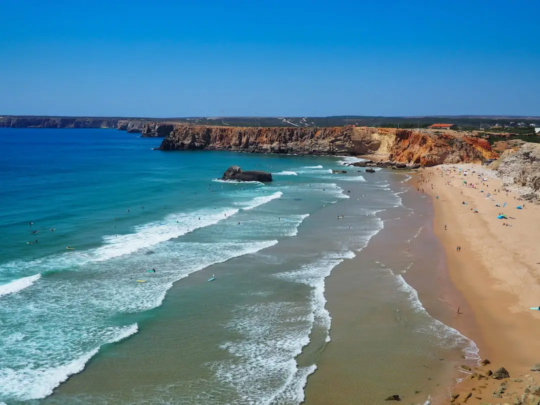 Praia Do Tonel, Sagres.. Golden sand beach and large waves with multiple surfers