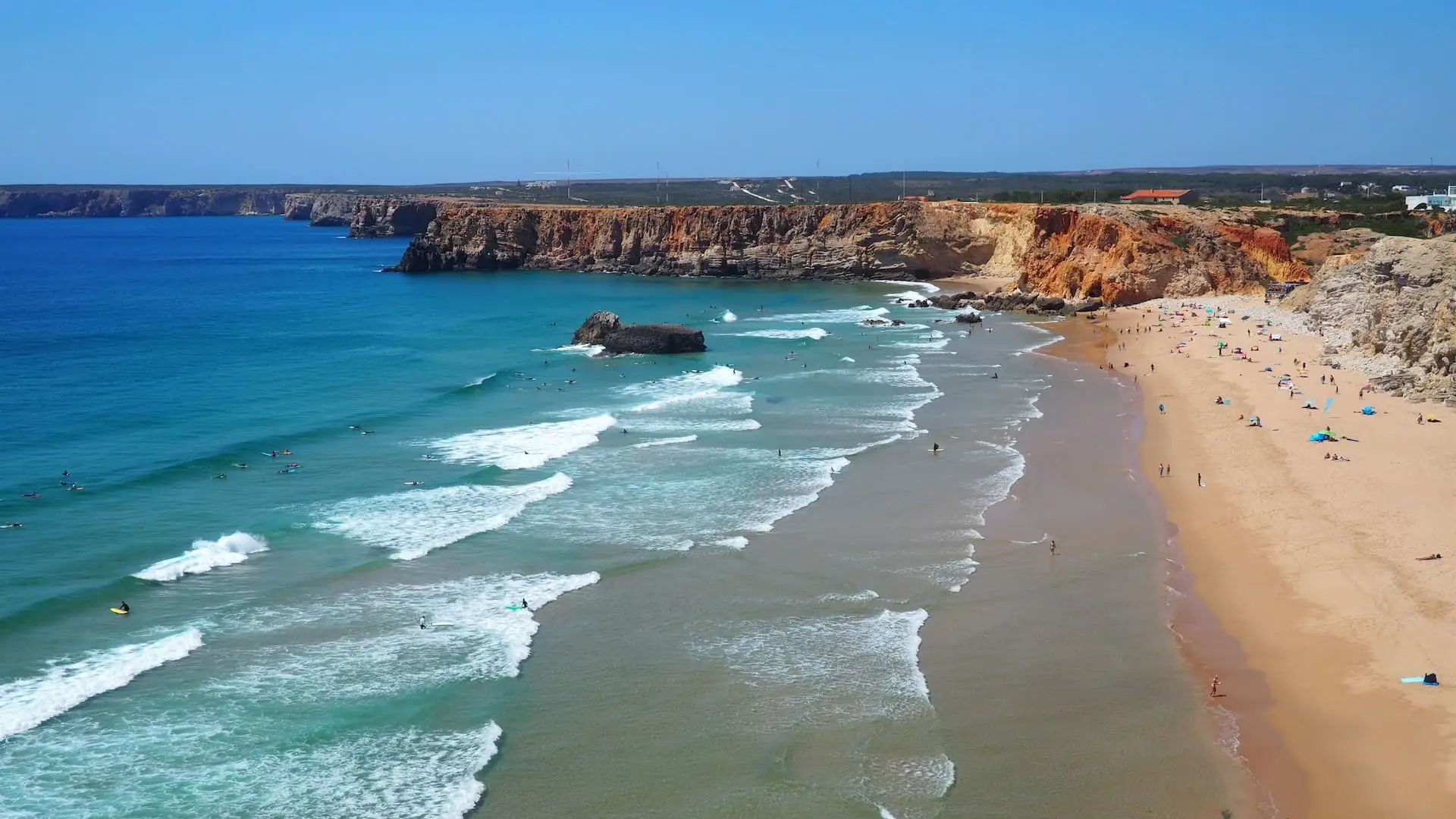 Praia Do Tonel, Sagres. Golden sand beach and large waves with multiple surfers