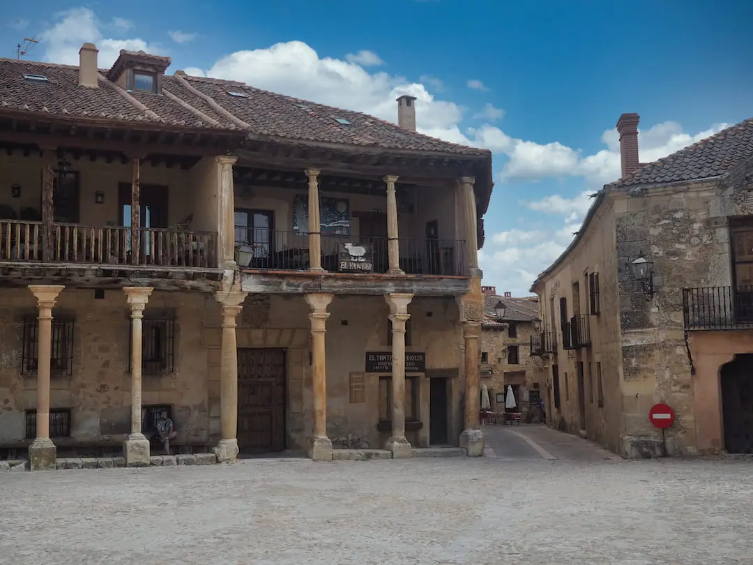 Day Trips from Madrid - Pedraza A medieval building with stone pillars on two storeys
