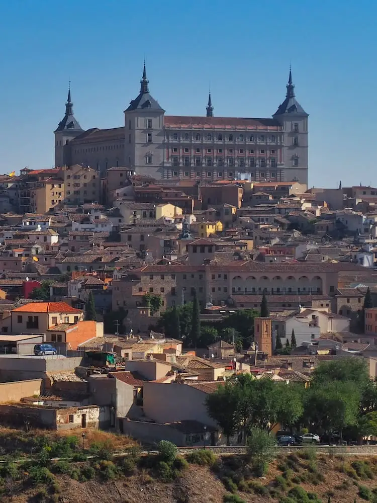 Day Trips from Madrid - Toledo A palace perched on a hill overlooking medieval houses