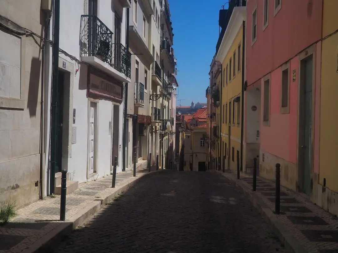 An empty street with yellow and red buildings