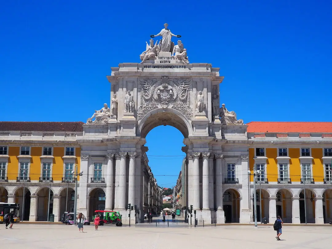 A stone arch is surrounded by statues