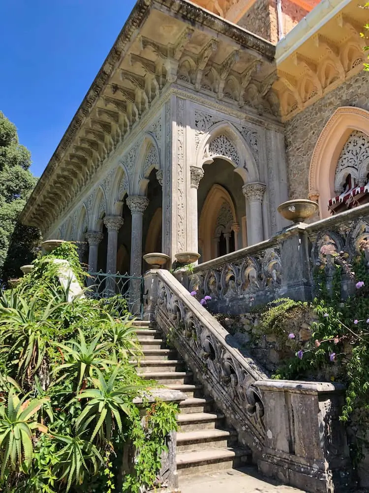 Steps lead down from an intricately designed building