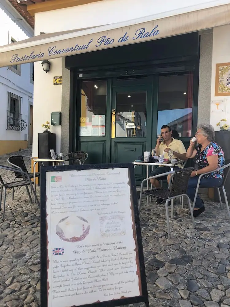2 people sitting outside a cafe