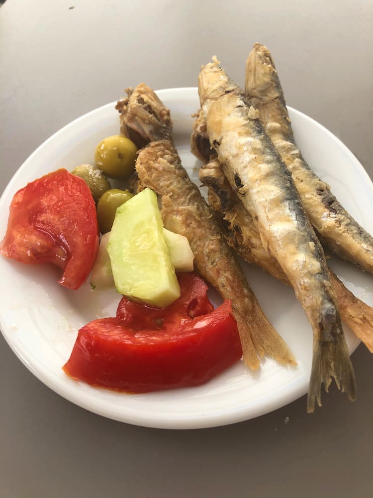 A plate of fried fish and salad
