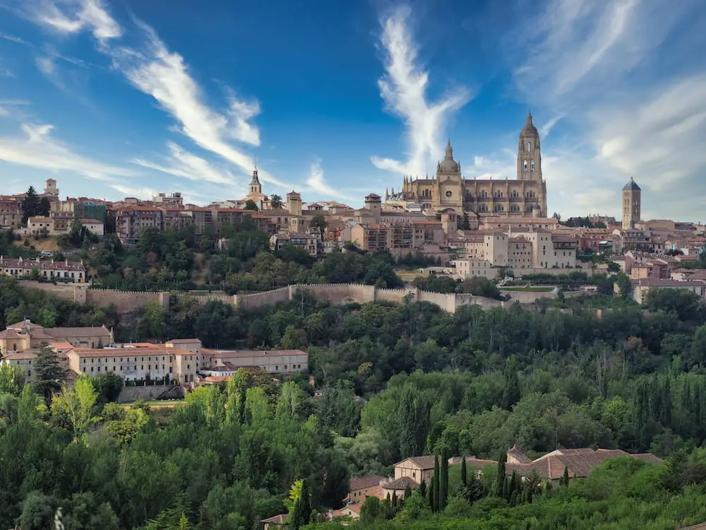 Segovia - the cathedral A town with a cathedral in the centre and trees in the foreground