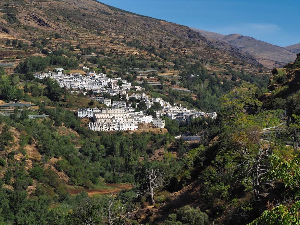 A white village on a green hillside
