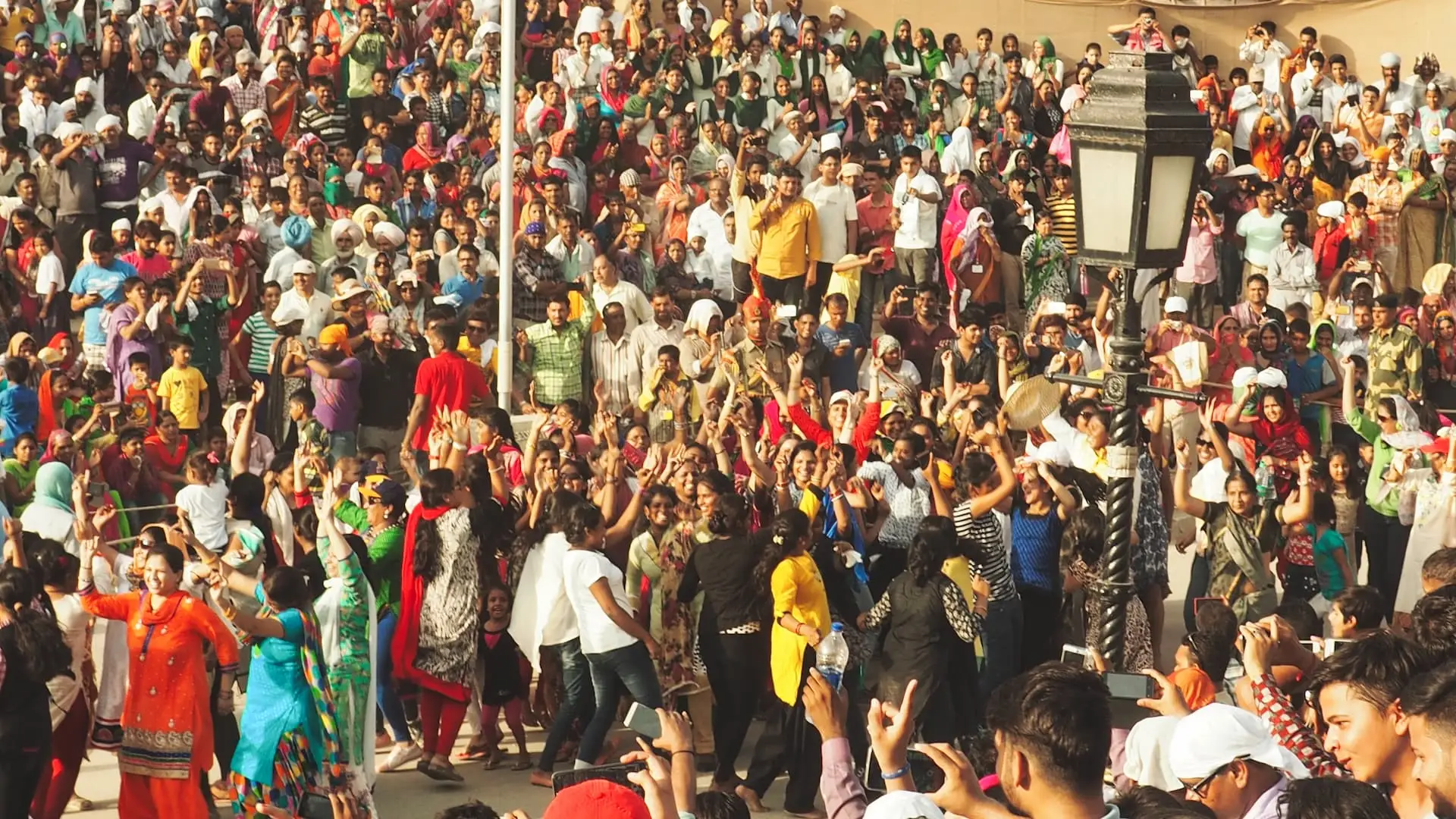 A crowd of people dancing with their arms in the air