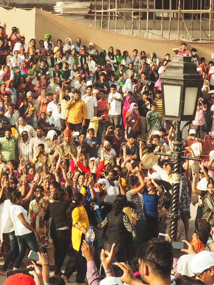 A crowd of people dancing with their arms in the air
