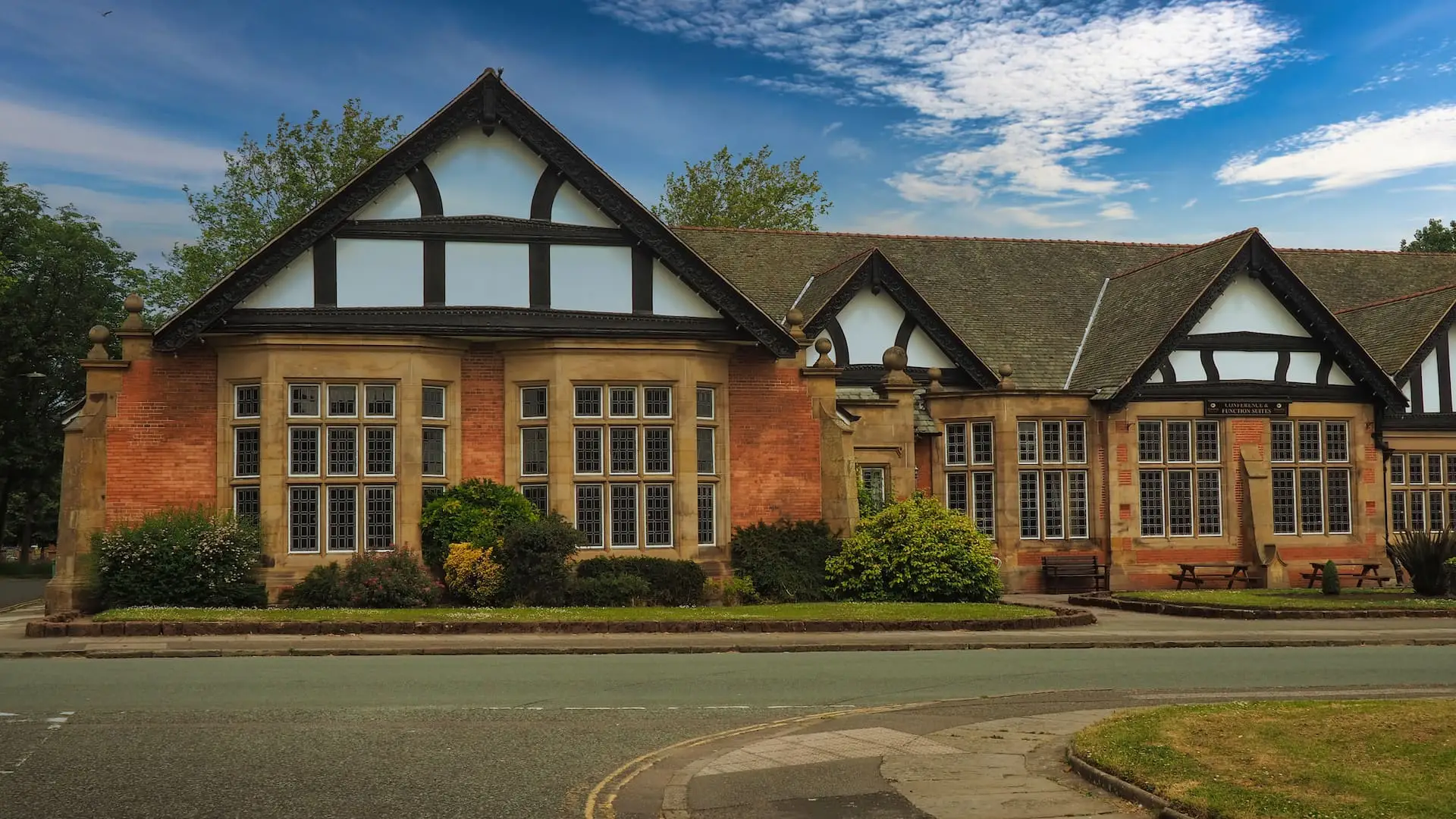 Low-rise sandstone building with half timbered black and white facade