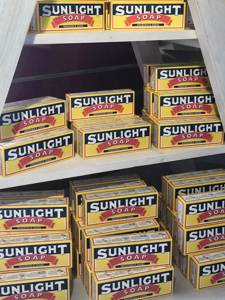Bars of soap in yellow packaging stacked on a shelf