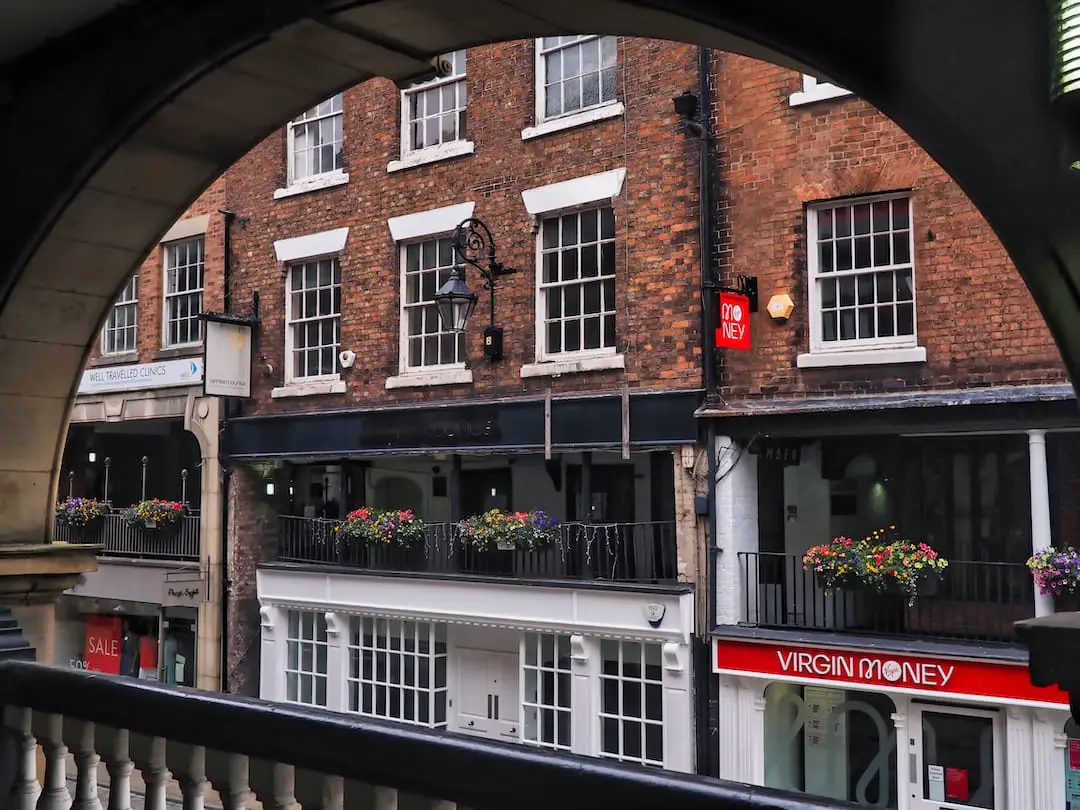 View of red-bricked buildings through an arch