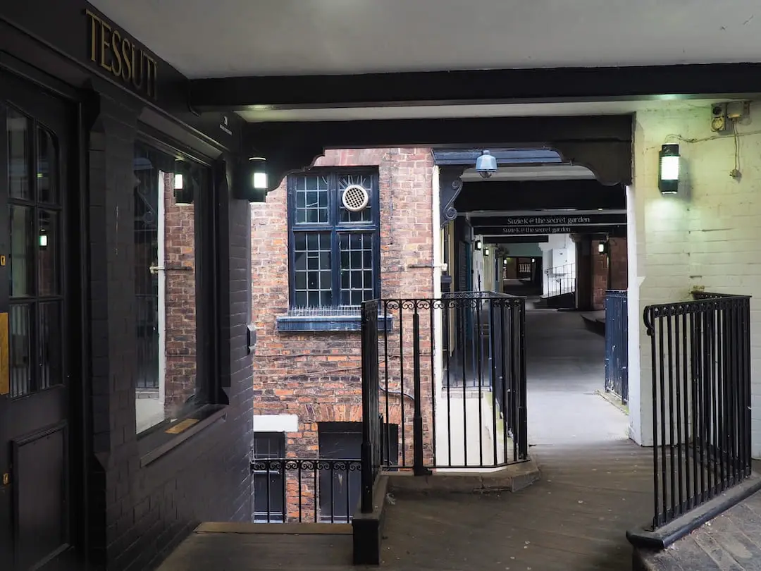 A passageway runs beneath a row of buildings