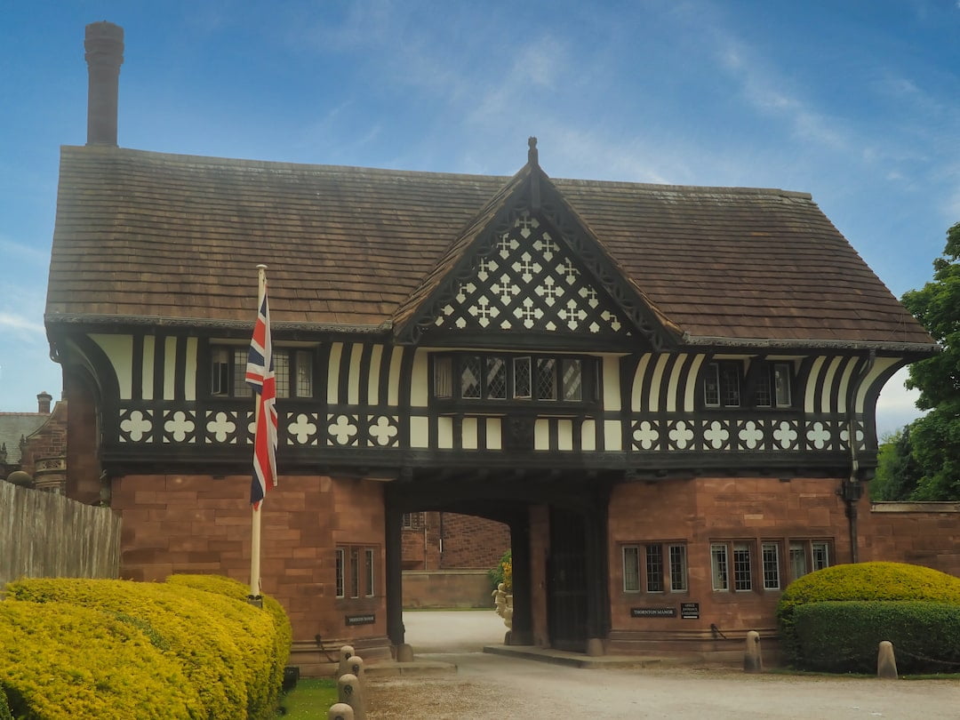 A building with a sandstone base and black-and-white half timbered first floor