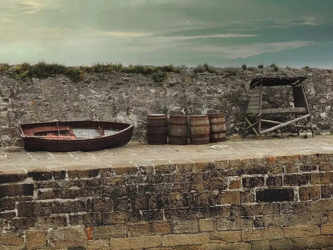 Charlestown Harbour - Quayside, Cornwall A rowing boat, rum barrels and a wooden structure on Charlestown's quayside
