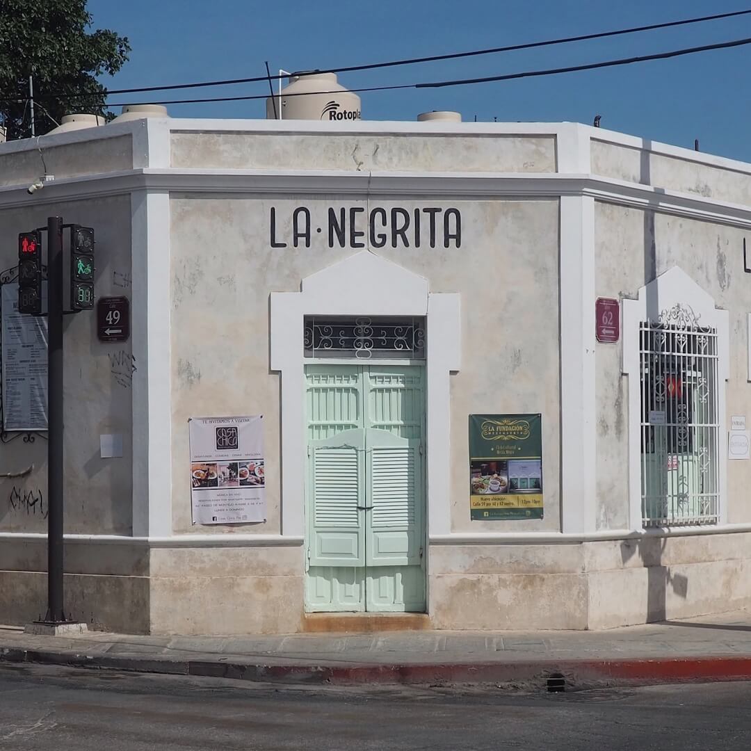 La Negrita cantina - a grey building with a green/blue stable door