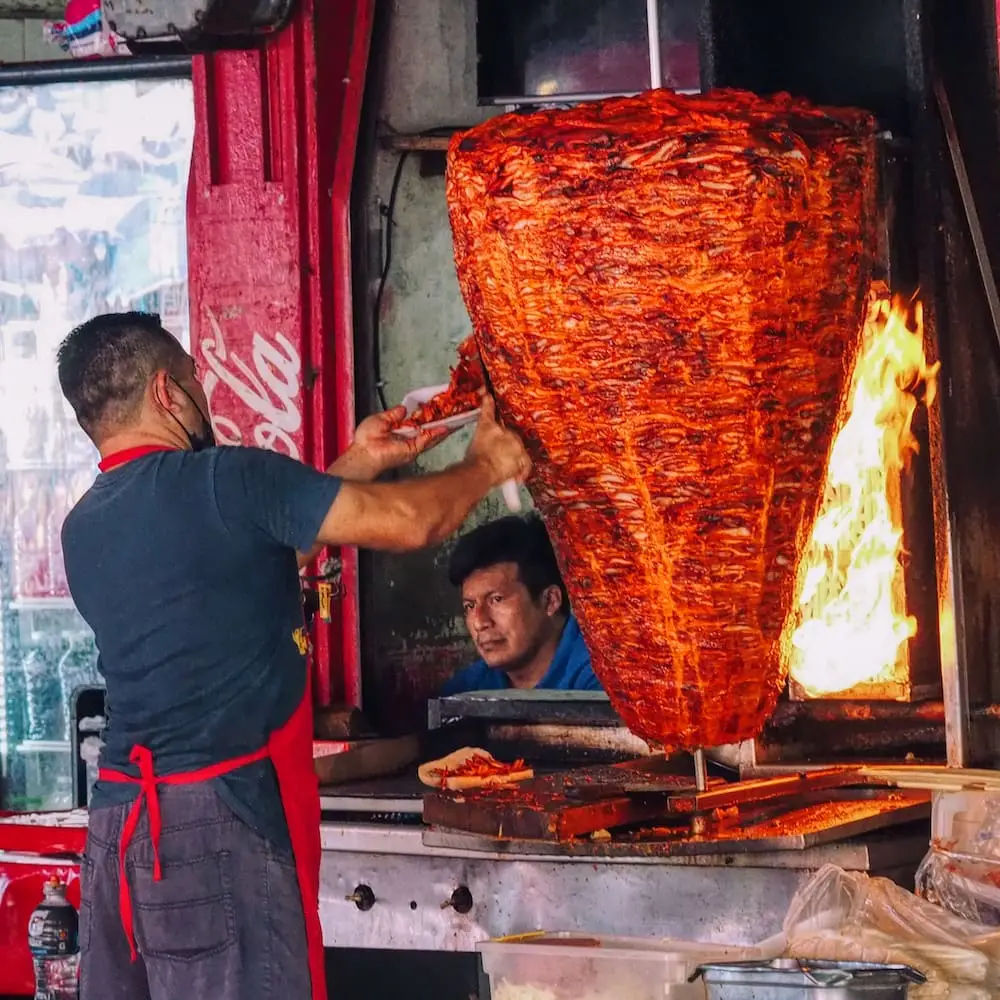 Al Pastor meat being carved.