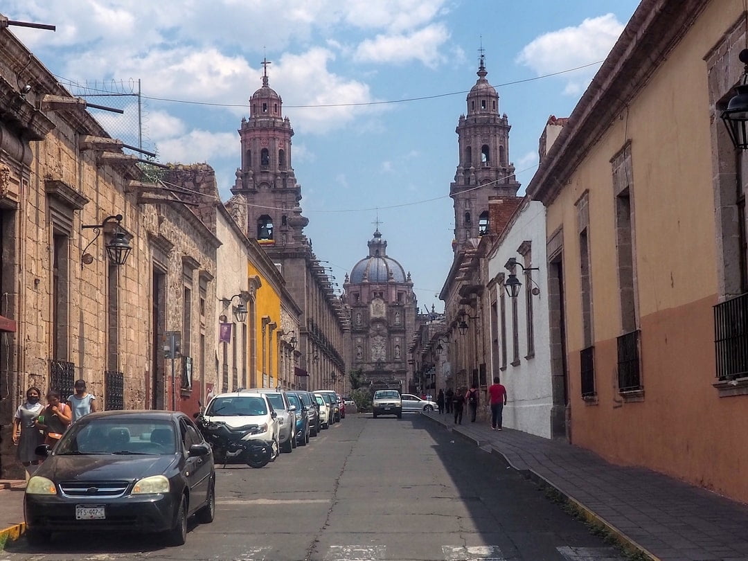 Morelia Cathedral looms behind a street in the foreground