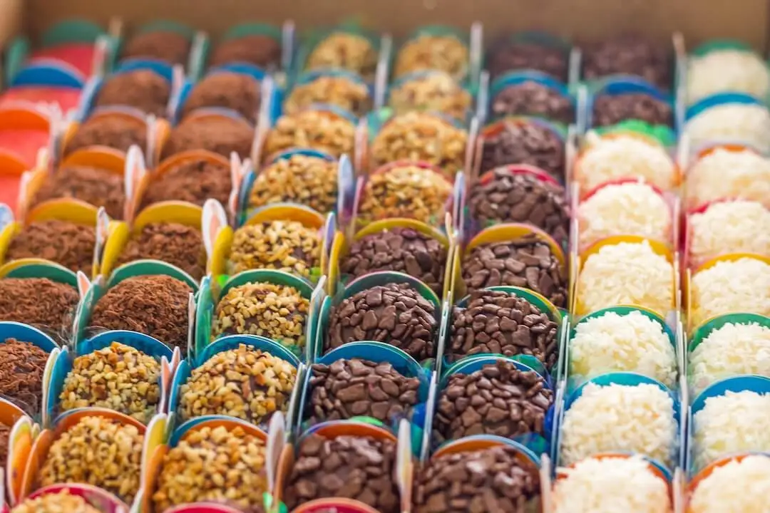 Rows of decorative chocolate balls in paper wrapping