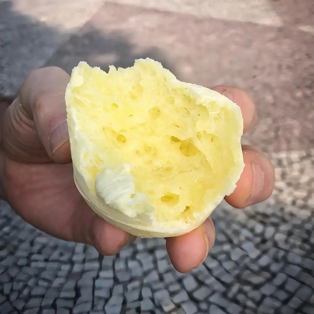 A small yellowish cheese dumpling split in half