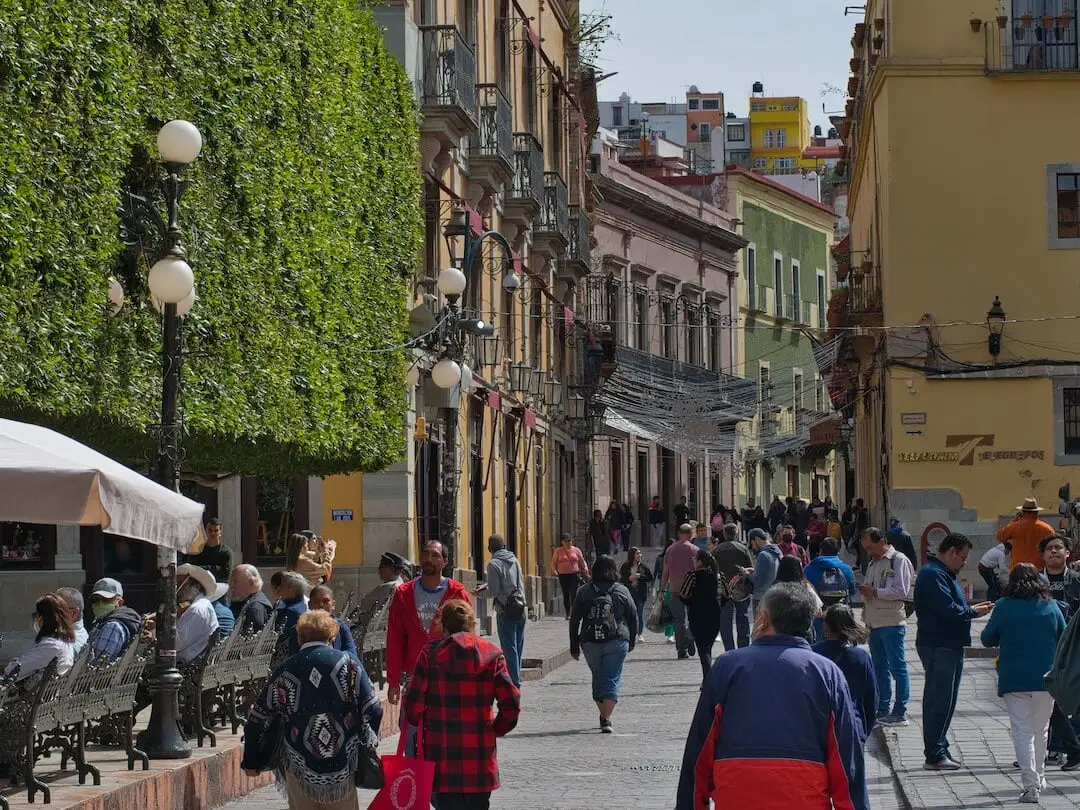 Jardin de la Union - Guanajuato Mexico A street with colonial era buildings and a tree-lined square in the foreground