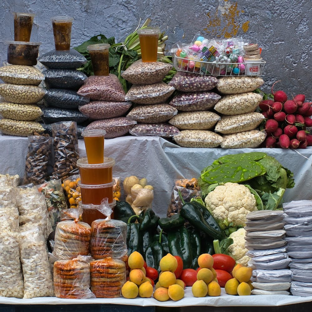 A stall full of corn, beans, vegetables and other food staples