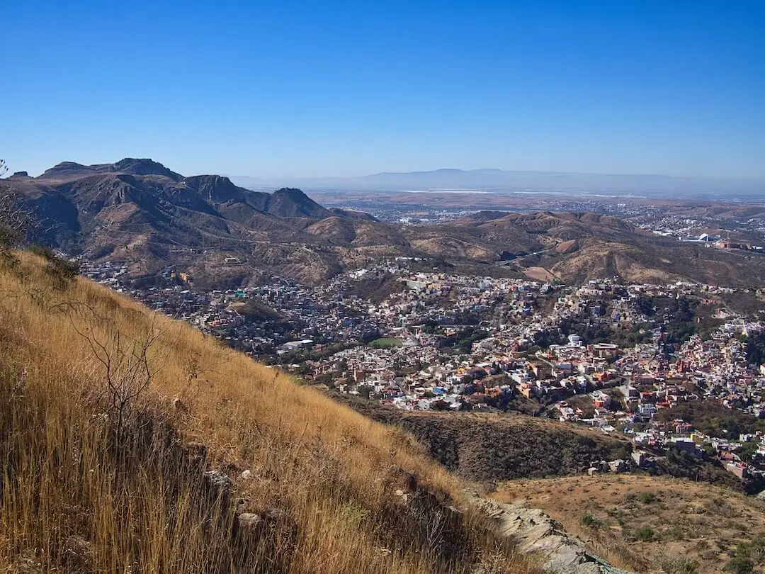 View of Guanajuato from Cerro de Sirena trail - Mexico. View of a town beneath a hillside