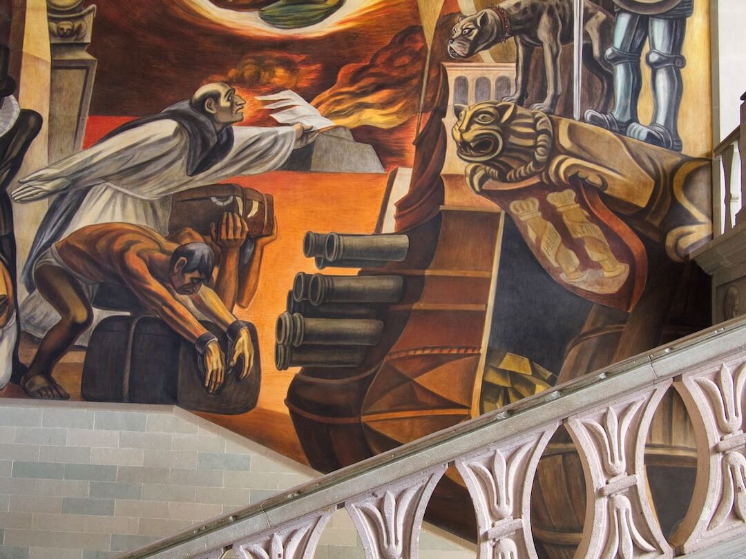 A staircase with a wall mural behind
