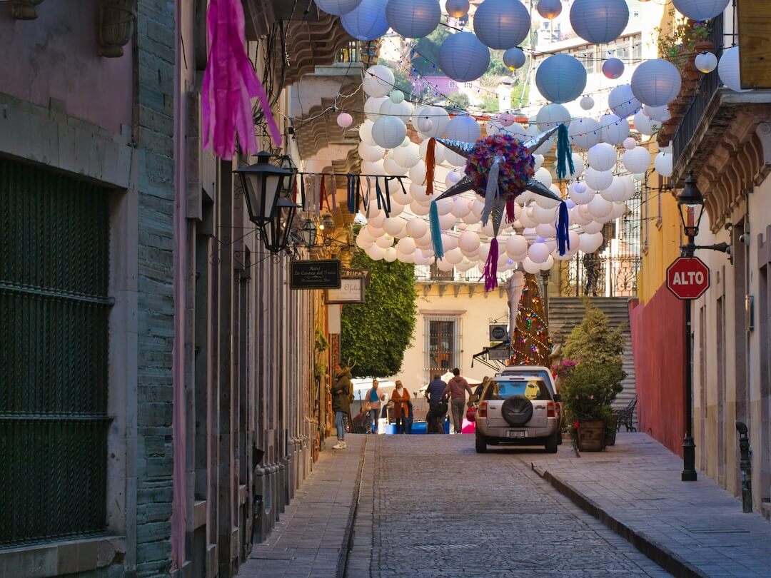  A street with decorative lanterns hanging across it