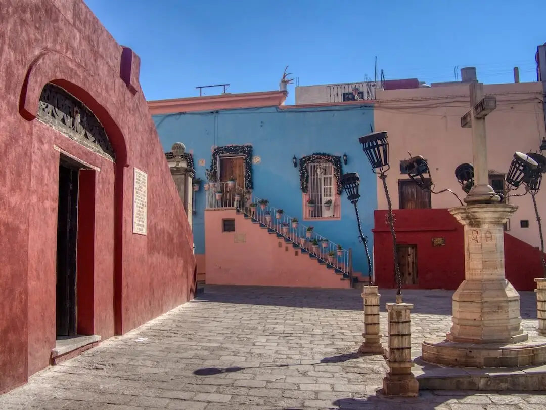 Pink and blue pastel coloured buildings on a square