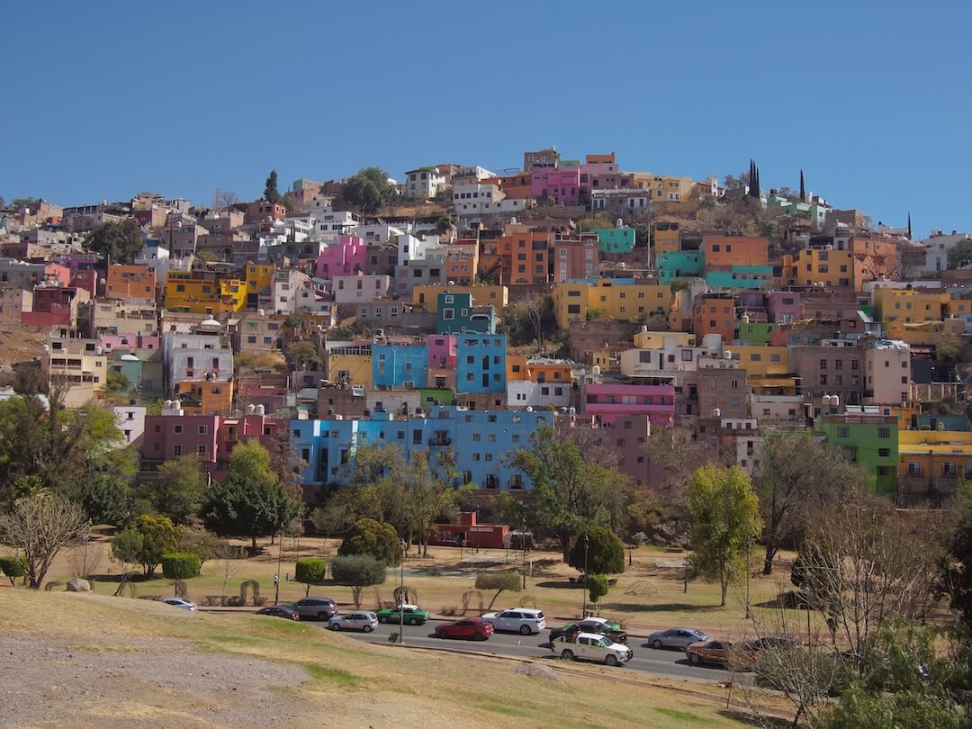 A hillside covered with pastel-coloured houses