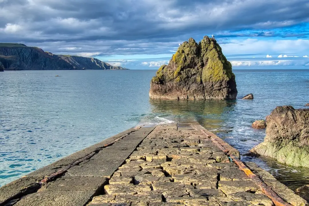 Pettico Wick Harbour - St Abbs Head - Scotland A disused harbour pier disappears into the sea