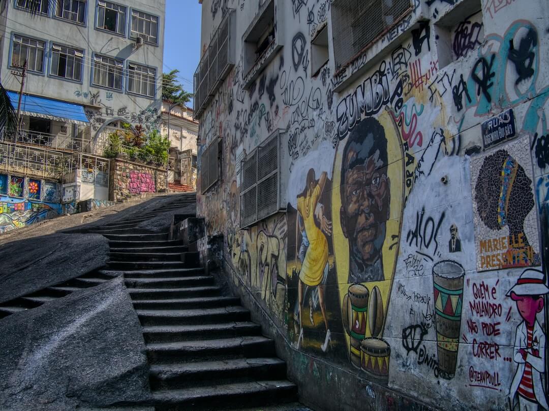 Stone steps lead uphill alongside graffiti-covered walls