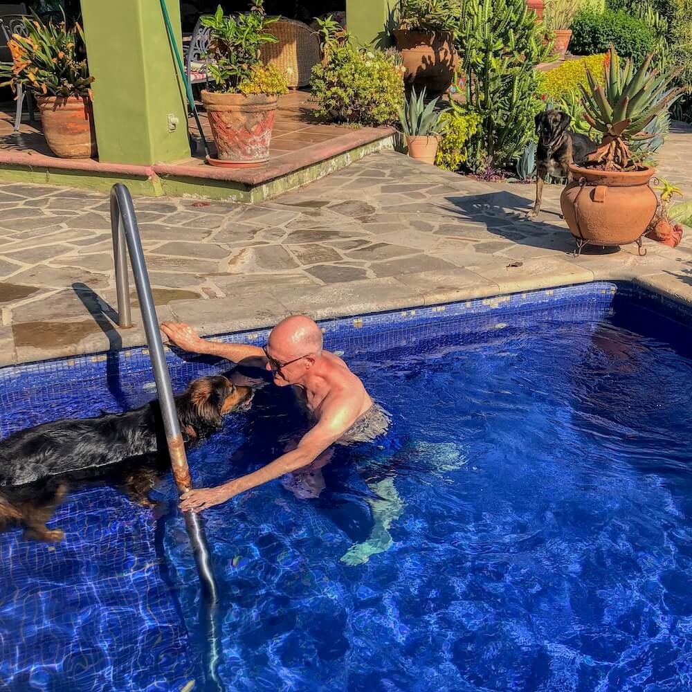 Ian with dog in a swimming pool