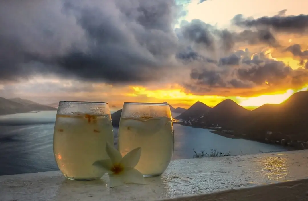 Hurricane Irma in BVI - Cocktails 2 cocktails resting on a wall with a sunset in the background
